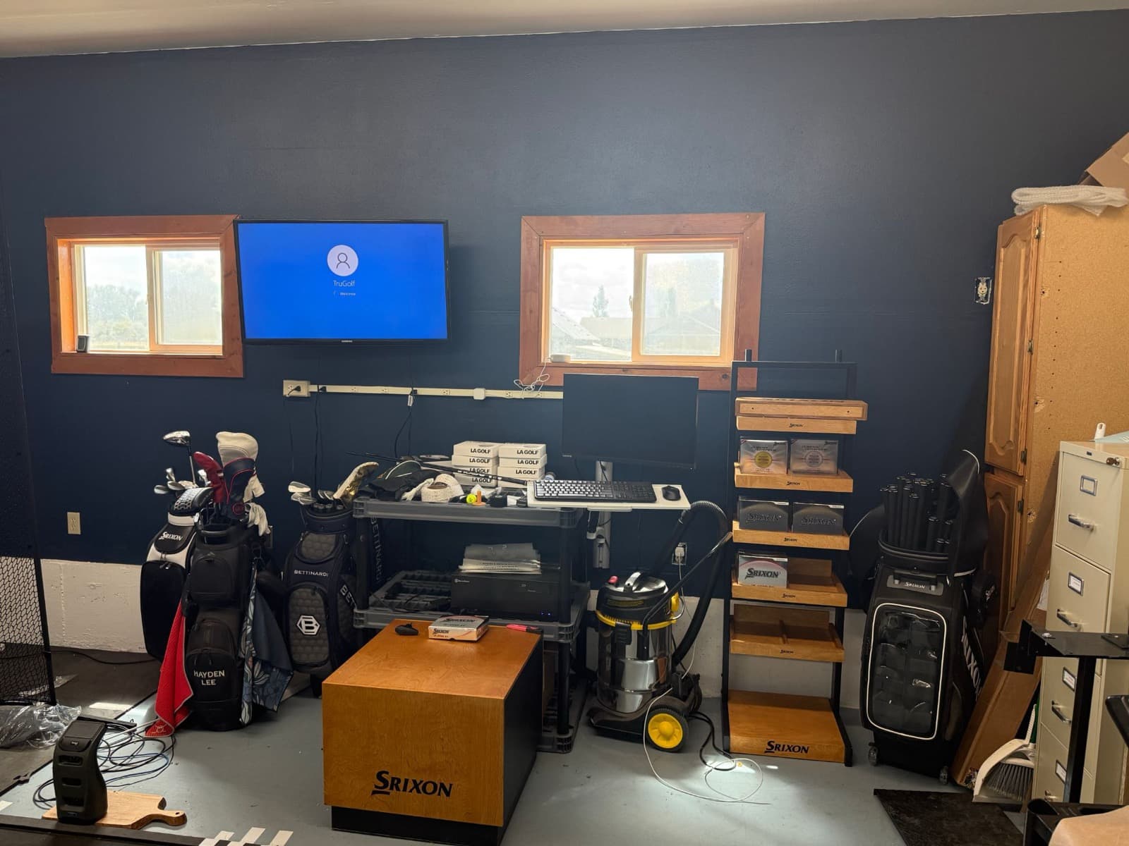 TruGolf display, ball display shelving, and golf bags in the shop